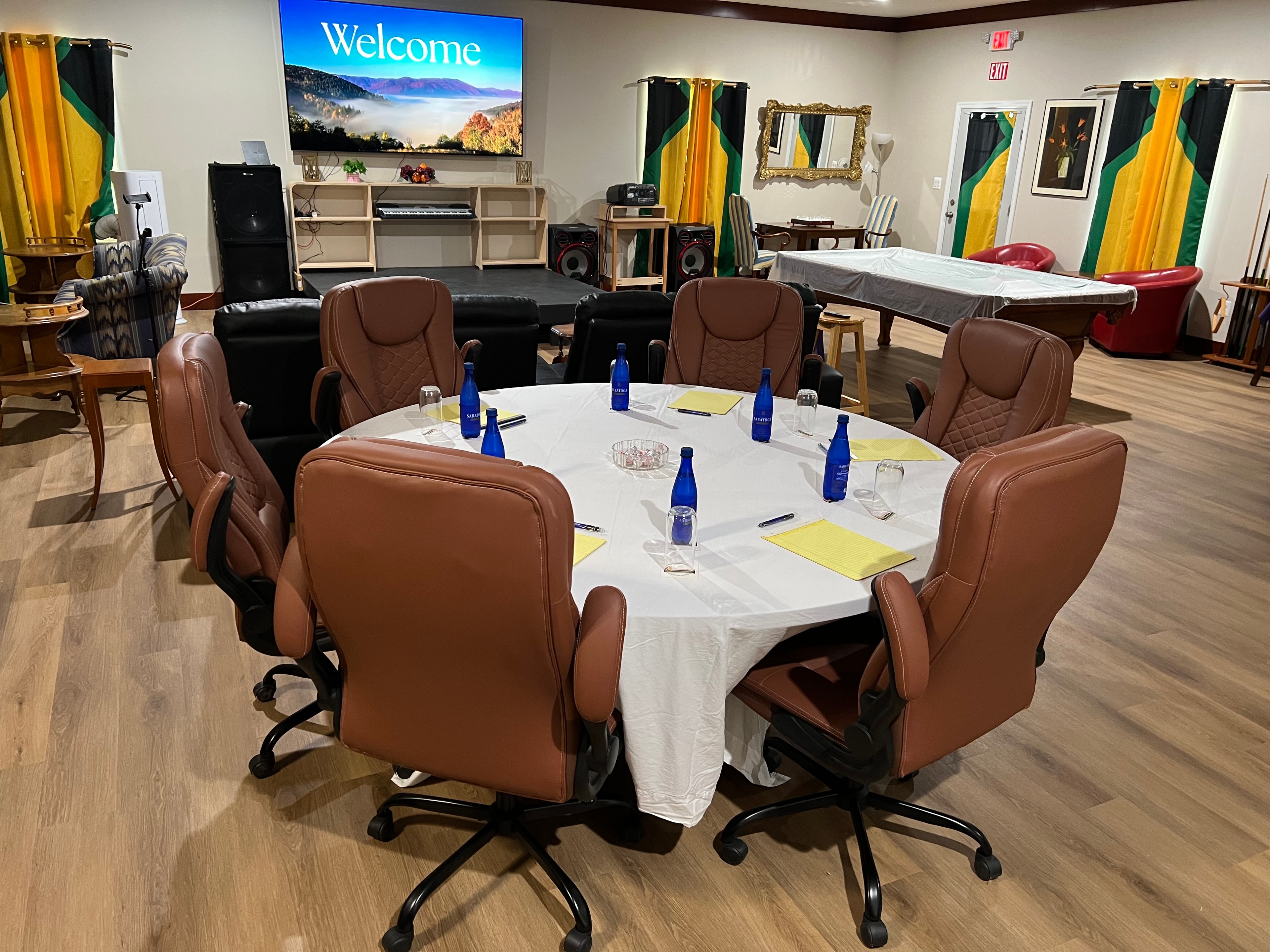 Conference room setup with round table and leather chairs