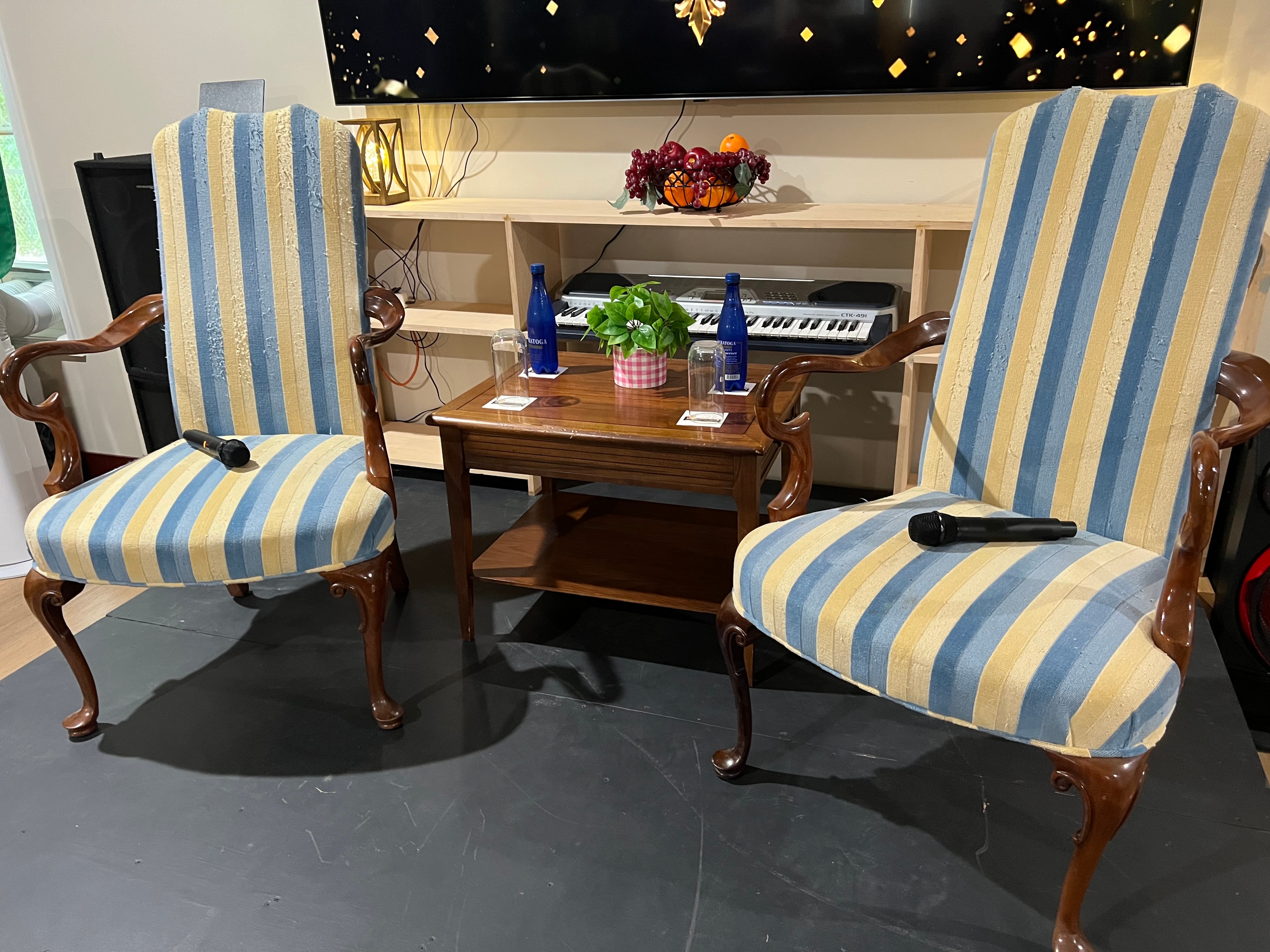 Striped upholstered chairs with microphones on stage