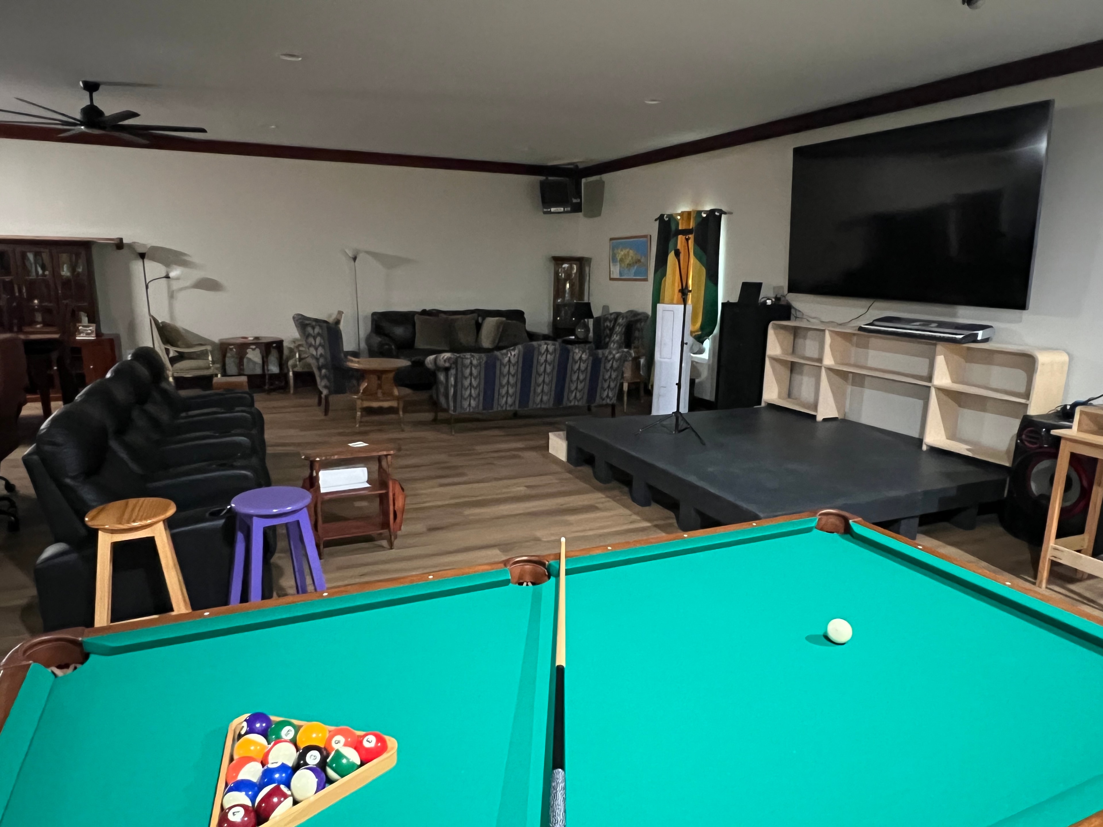 Pool table and stage view at Carib Comfort entertainment room