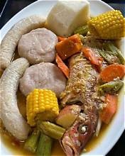 Carib Comfort breakfast — fish tea soup with corn, banana and dumplings