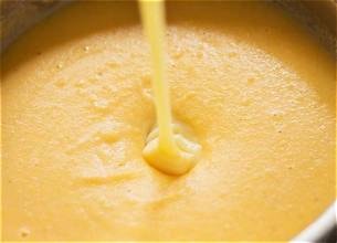 Carib Comfort breakfast — creamy cornmeal porridge being poured