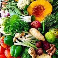 Carib Comfort breakfast — fresh vegetables including pumpkin, peppers, cauliflower and greens