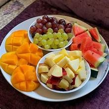 Carib Comfort breakfast — fresh fruit platter with mango, watermelon and grapes