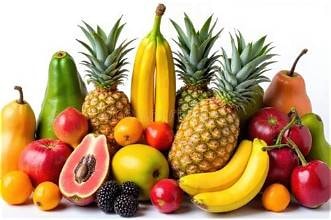 Carib Comfort breakfast — tropical fruit display with pineapples, bananas, papaya and berries