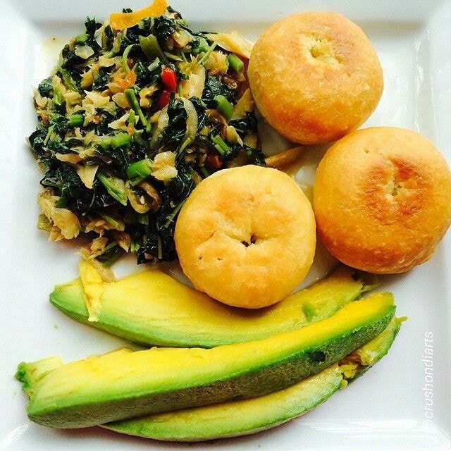 Carib Comfort breakfast — callaloo with saltfish, fried dumplings and avocado