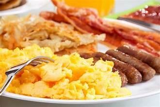 Carib Comfort breakfast — scrambled eggs with sausage and hash browns